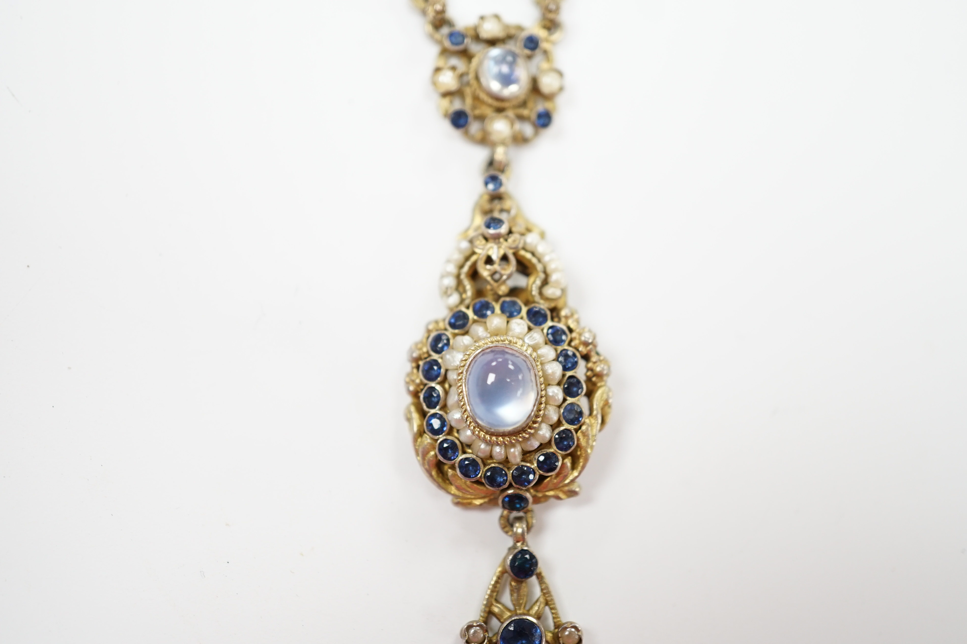 A 19th century Austro Hungarian, gilt white metal, moonstone, split pearl and gem set drop pendant necklace, overall 56cm.